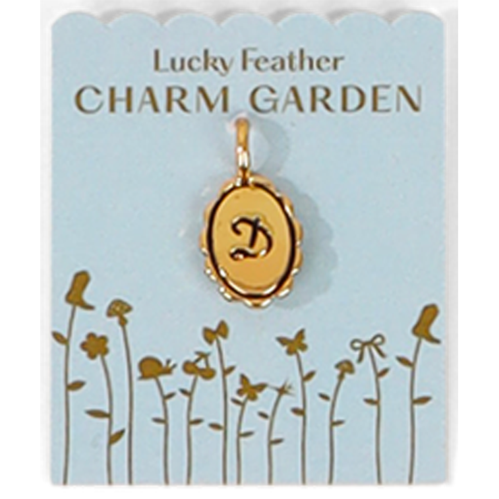 A gold letter "D" pendant on a "Lucky Feather Charm Garden" card.