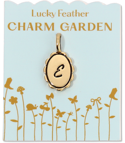 A gold letter 'E' charm dangles above a garden-themed card from 'Lucky Feather CHARM GARDEN'.