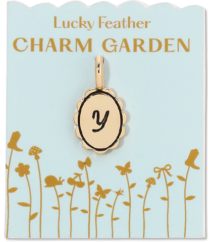 A gold charm with the letter "y" on a pale blue card labeled "Lucky Feather Charm Garden".
