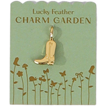 A golden cowboy boot charm hangs on a green card that says "Lucky Feather CHARM GARDEN".