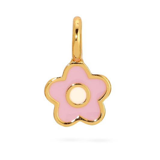Close-up of a small, gold-trimmed charm of a pink flower with a white center on a black background.