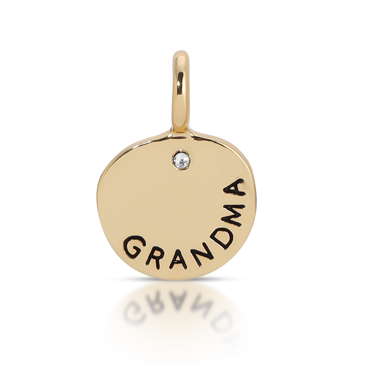A gold-toned charm with a loop at the top features the word "GRANDMA" and a small gemstone.