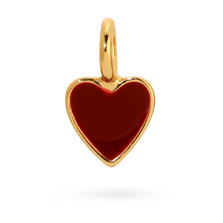 A small gold heart charm with a red enamel fill.