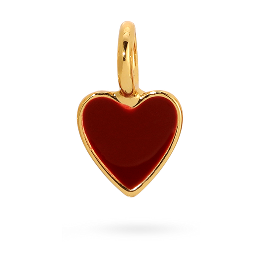 A small gold heart charm with a red enamel fill.