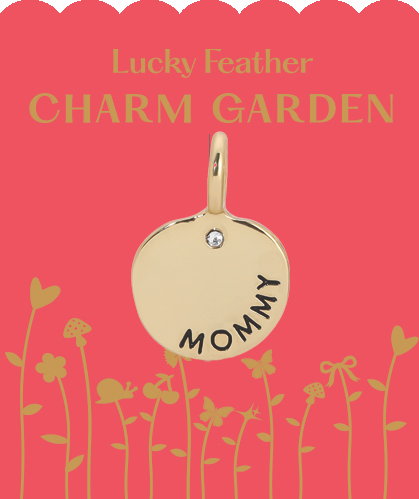 A golden "Mommy" charm on a pink "Lucky Feather Charm Garden" card with a floral and butterfly design.