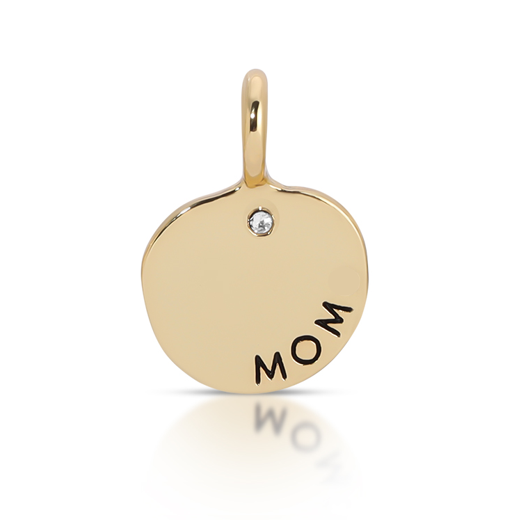 A gold charm with a loop at the top displays the word "MOM" and a small clear gem.