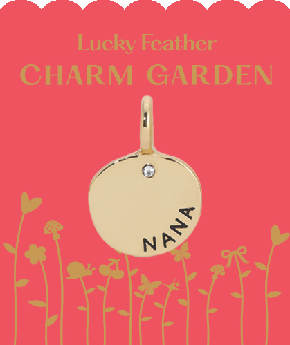 A golden charm pendant with 'NANA' engraved, set against a pink floral-themed card.
