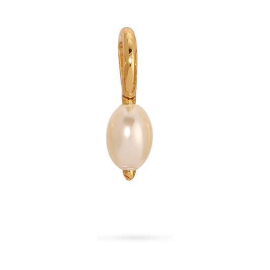 Close-up of a gold earring with a pearl charm.