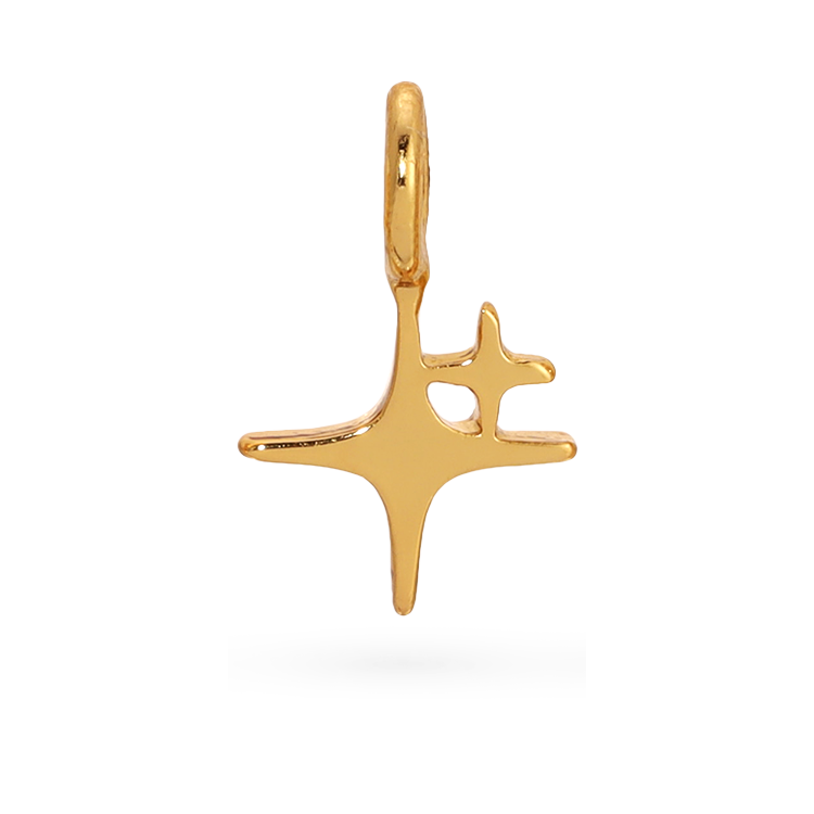 Close-up of a gold charm with a star-like design on a black background.