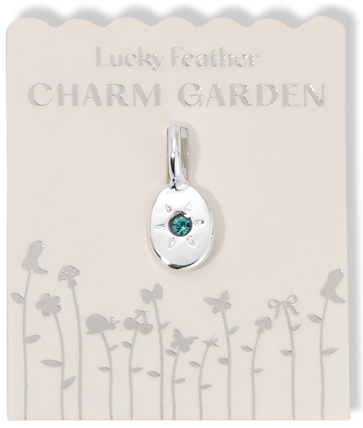 A silver charm with a turquoise stone is displayed on a card labeled "Lucky Feather CHARM GARDEN".