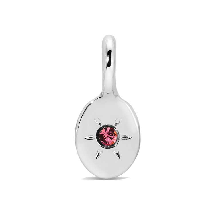 A silver pendant with a pink gem in a starburst setting.
