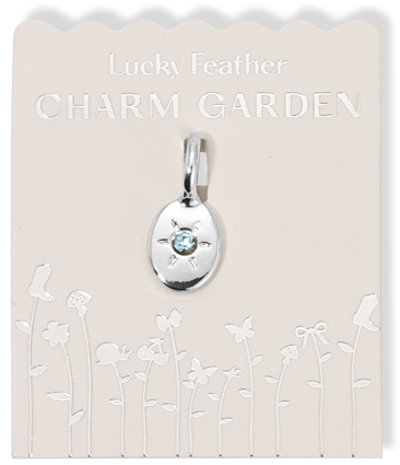 A "Lucky Feather Charm Garden" pendant necklace on its packaging.