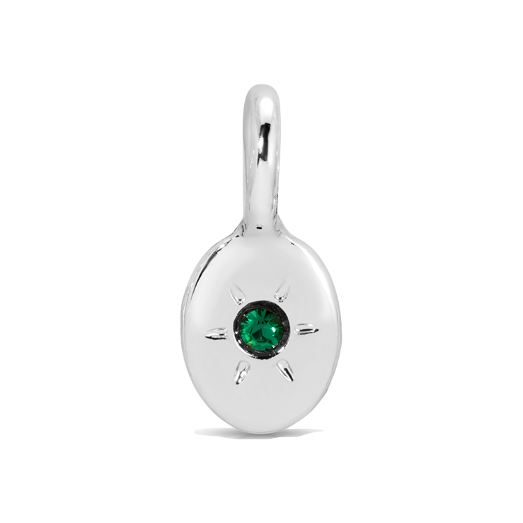 Close-up of a silver pendant with a green gem.