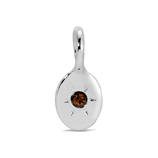 A silver charm with a brown jewel-like stone in the center is displayed.