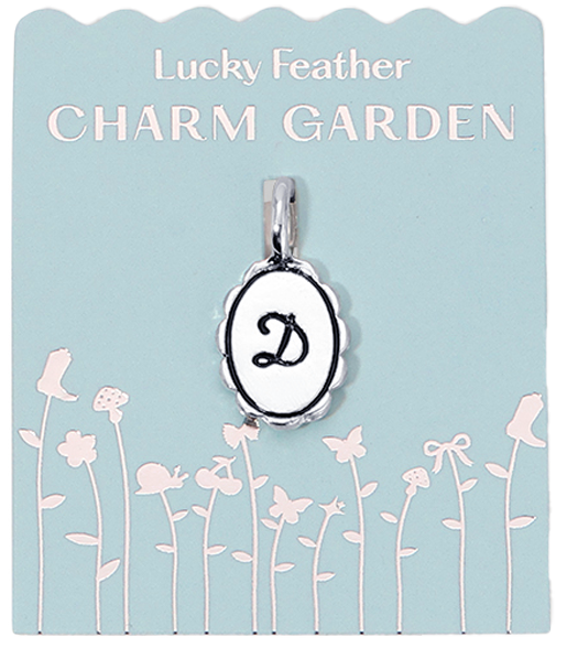 The "Lucky Feather Charm Garden" package features a charm with the letter "D" against a light blue background decorated with illustrations of flowers and butterflies.