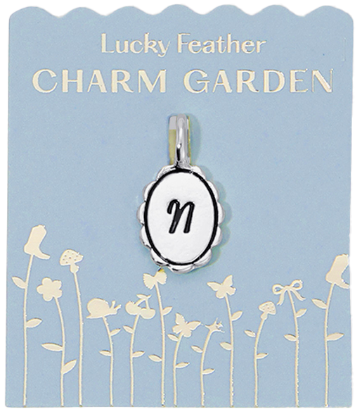A charm with the letter N hangs on a "Lucky Feather Charm Garden" card.
