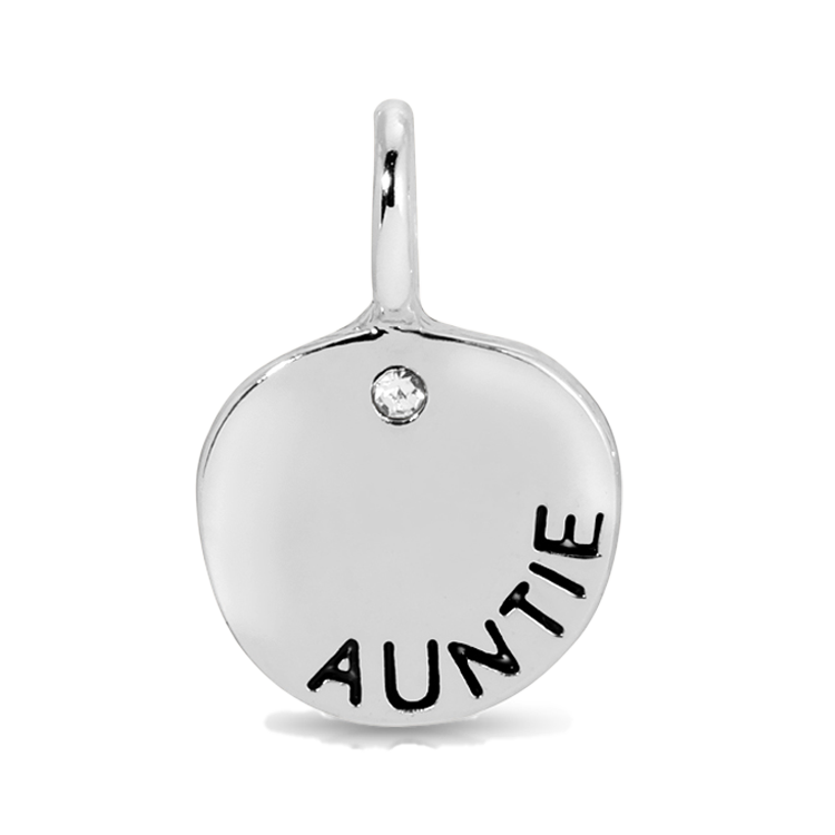 A silver pendant with the word "AUNTIE" inscribed on it and a small clear gem.