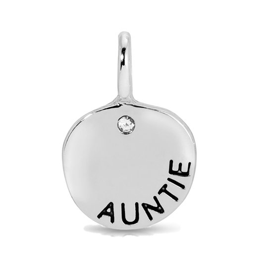 A silver pendant with the word 'AUNTIE' inscribed on it and a small clear gem.