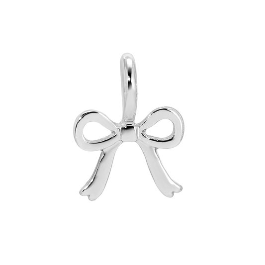 A silver bow charm is on a black and white background.