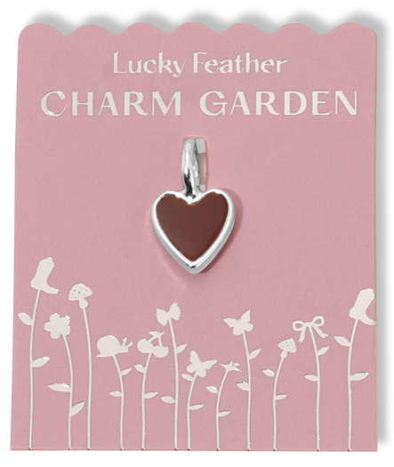 A brown heart charm hangs on a pink card with a silver floral design and the text "Lucky Feather CHARM GARDEN".