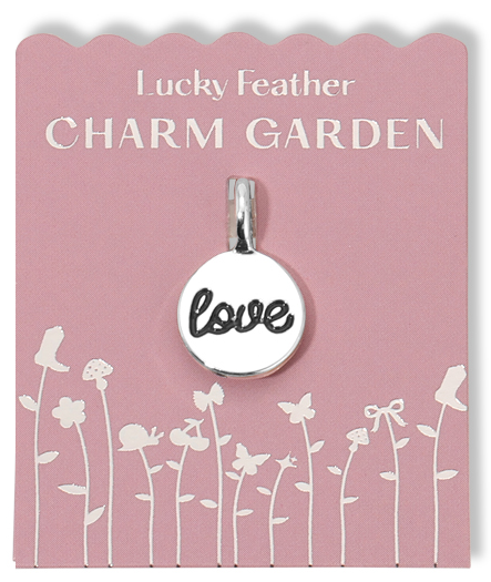 Love charm on a pink "Lucky Feather Charm Garden" display card with flower graphics.