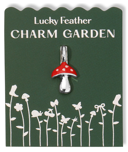 A mushroom charm on a green card labeled "Lucky Feather CHARM GARDEN."