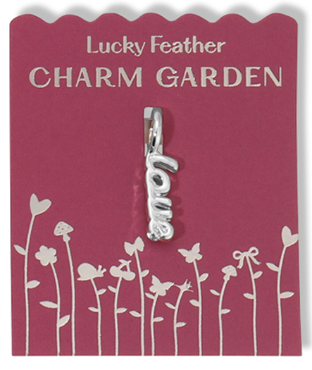 A "love" charm hangs on a "Lucky Feather Charm Garden" card.