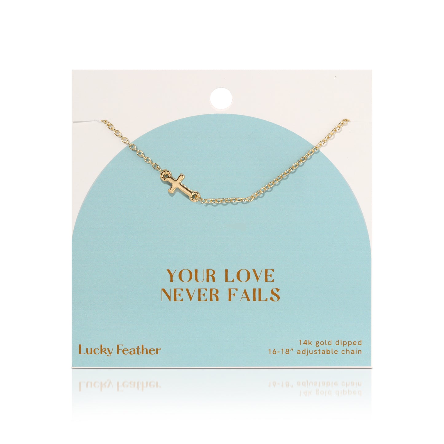 A 14k gold-dipped necklace with a cross pendant on a display card that reads "Your Love Never Fails."