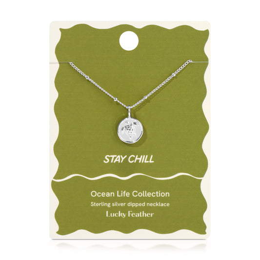 Sterling silver dipped necklace with a turtle pendant on a green and cream card that says 'Stay Chill'.