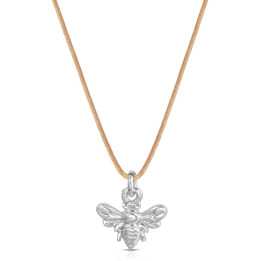 A necklace with a tan cord and a silver-colored bee pendant is centered on a white background.