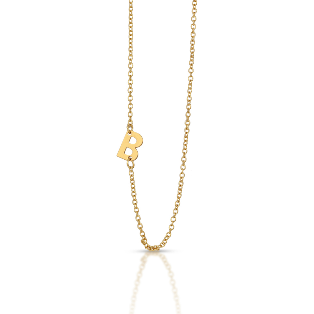 A gold necklace with a letter B pendant.