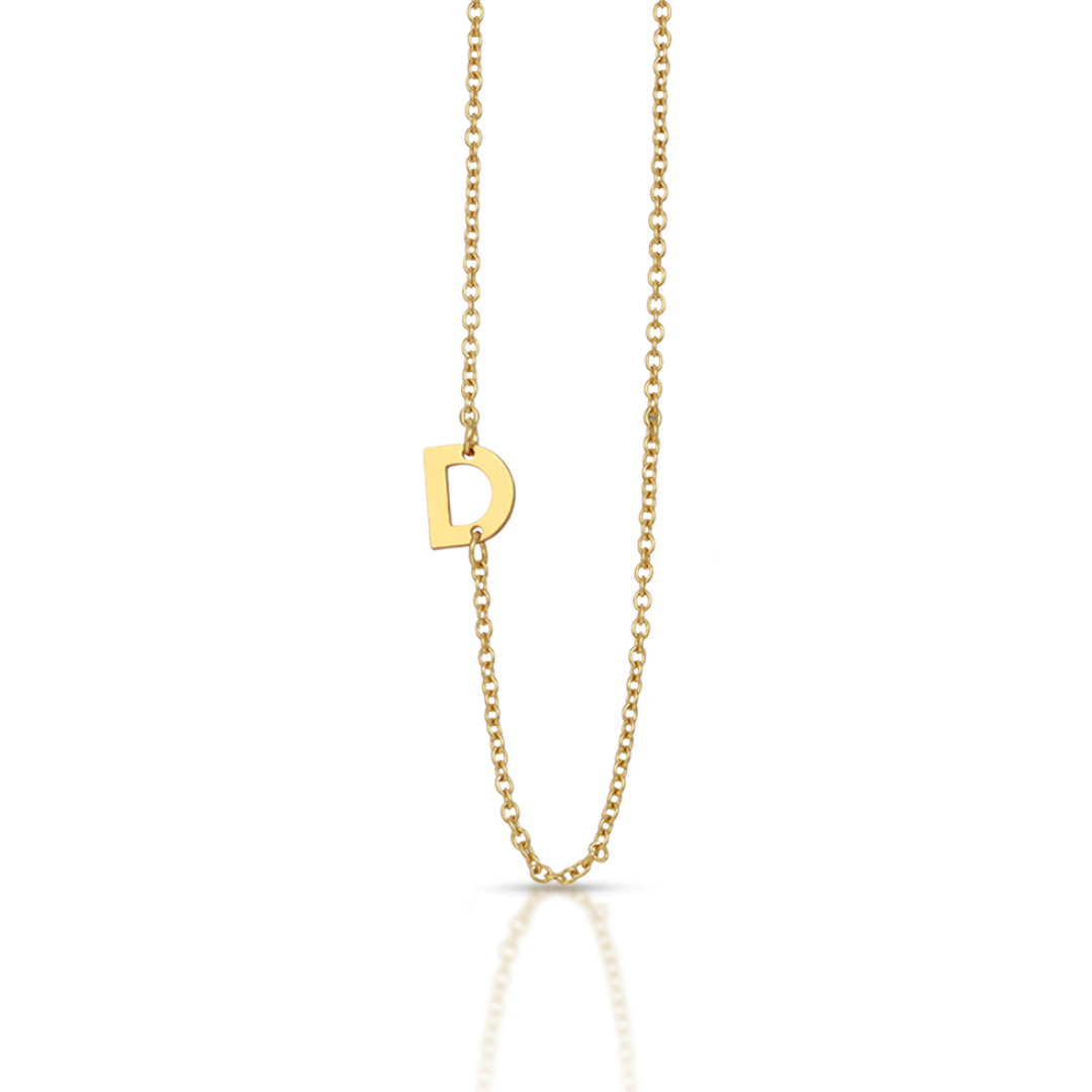 A gold necklace with a "D" pendant is displayed against a white background.