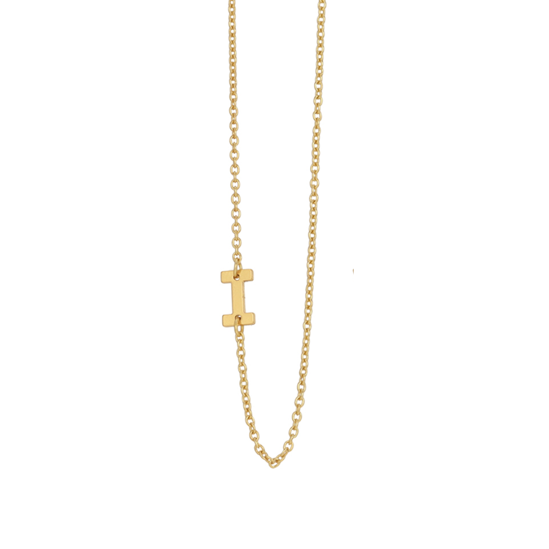 A gold chain necklace features a letter "I" pendant.