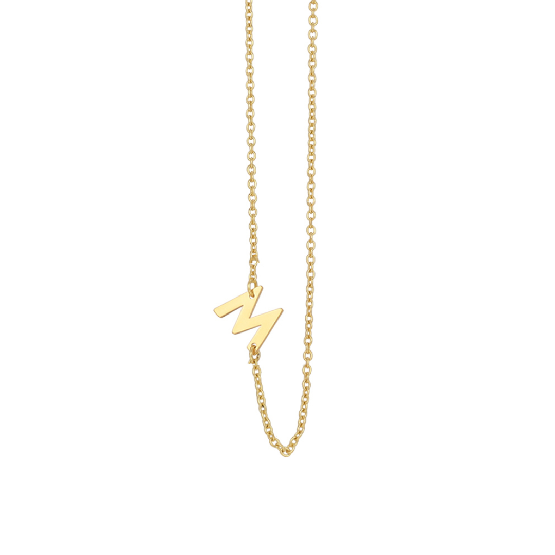 A gold chain necklace with a sideways "M" pendant on a white background.