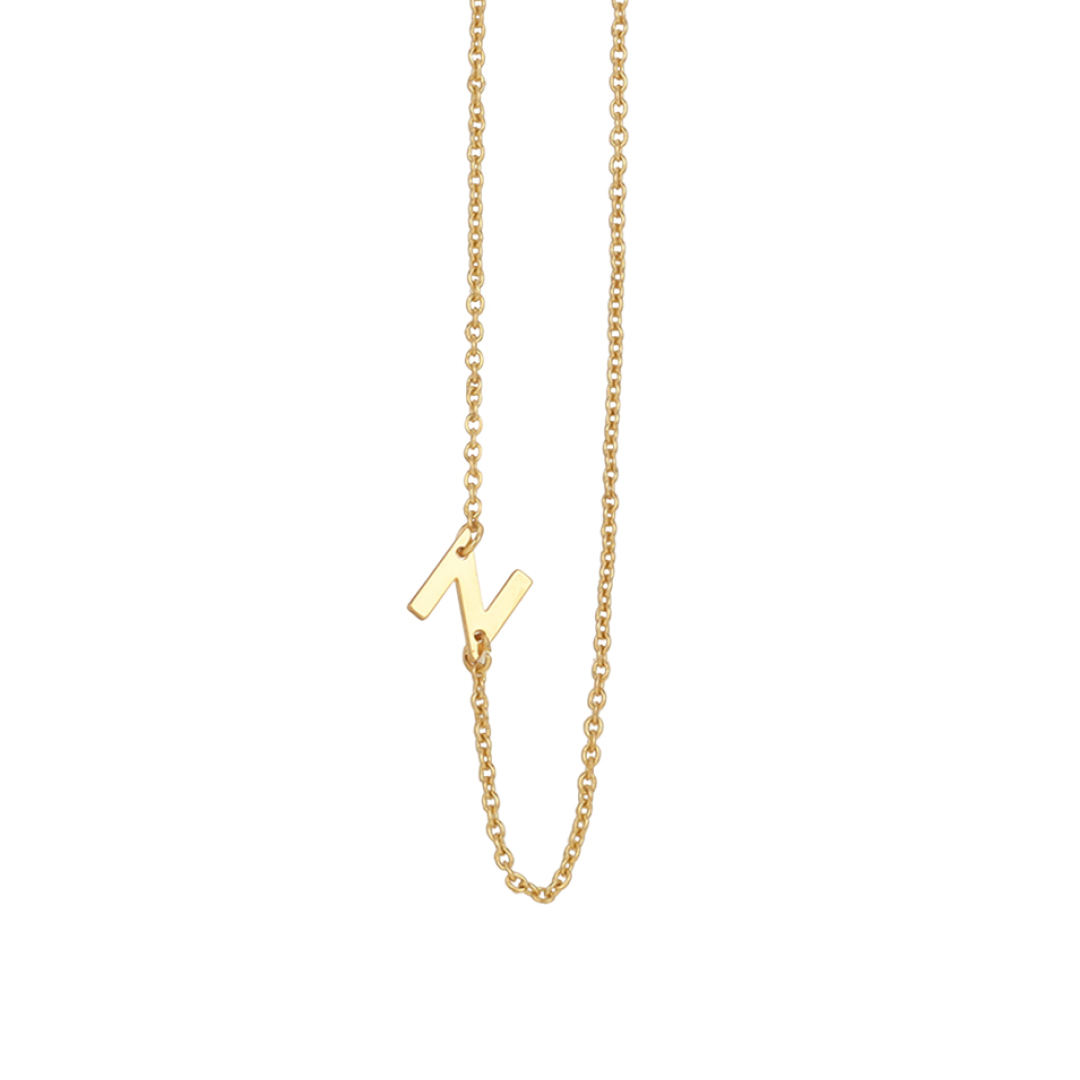 A gold chain necklace with an "N" pendant.