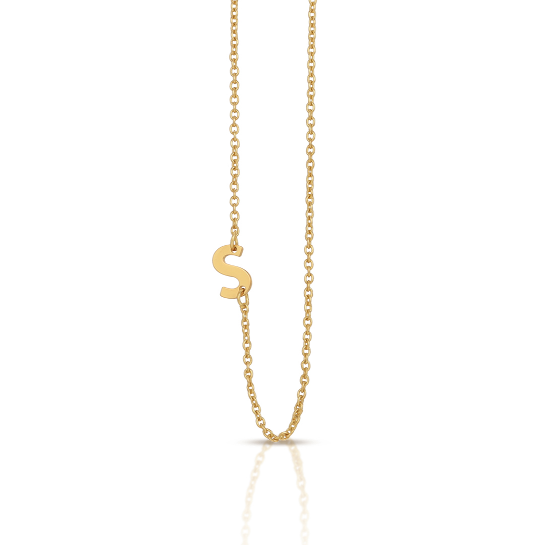 A gold chain necklace with a gold "S" pendant.