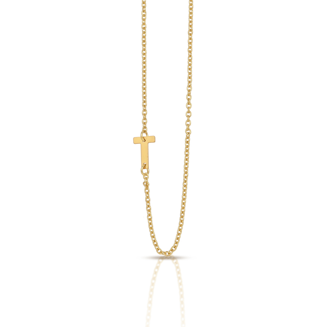 A gold chain with a sideways "T" pendant is centered on a white background.