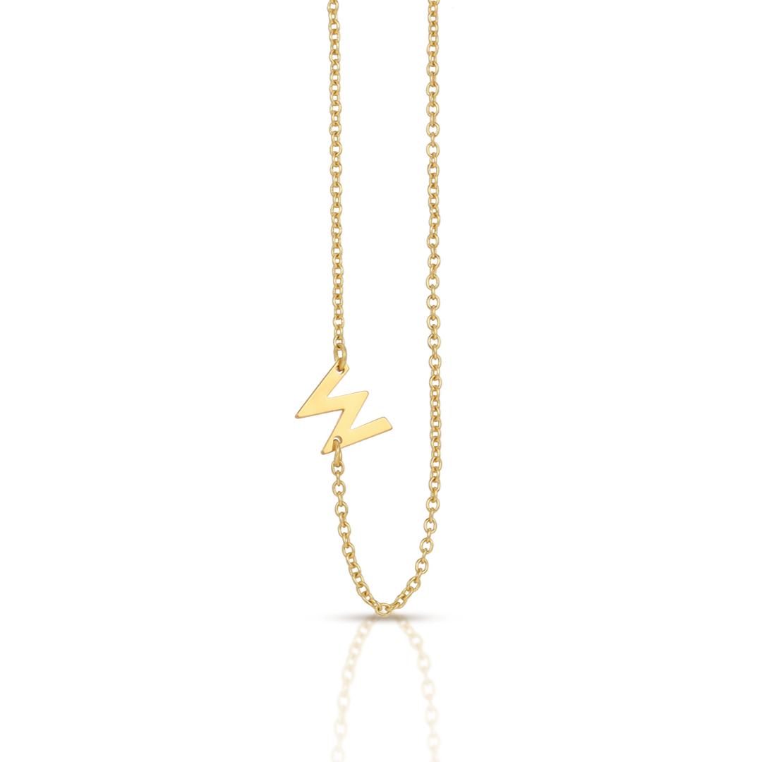 A gold chain necklace features a "W" shaped charm.