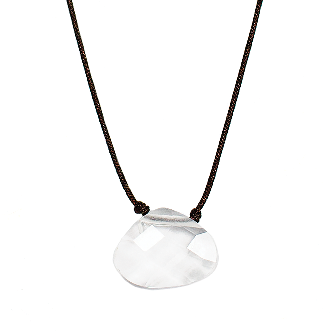 A clear, faceted pendant hangs from a brown cord necklace.