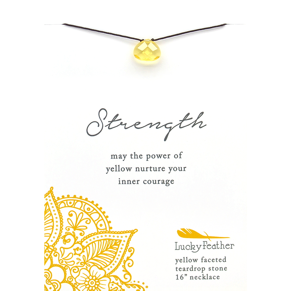 A yellow teardrop pendant on a cord is presented on a card with the word "Strength" and the phrase "may the power of yellow nurture your inner courage."