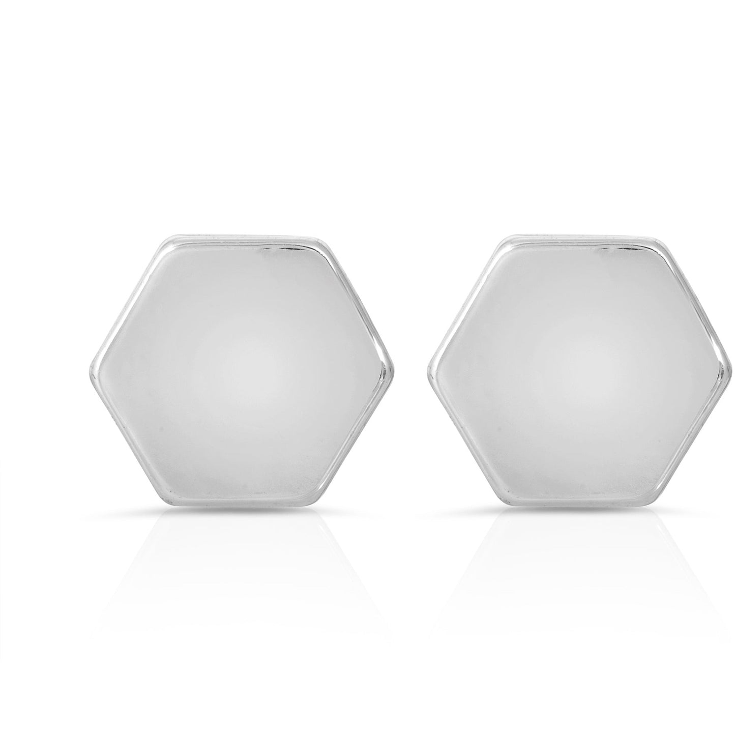 Two silver, hexagonal-shaped objects are on a white surface, casting subtle reflections.