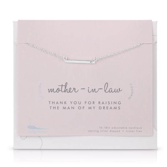 A silver bar necklace on a pink card that reads 'mother-in-law, Thank you for raising the man of my dreams.'