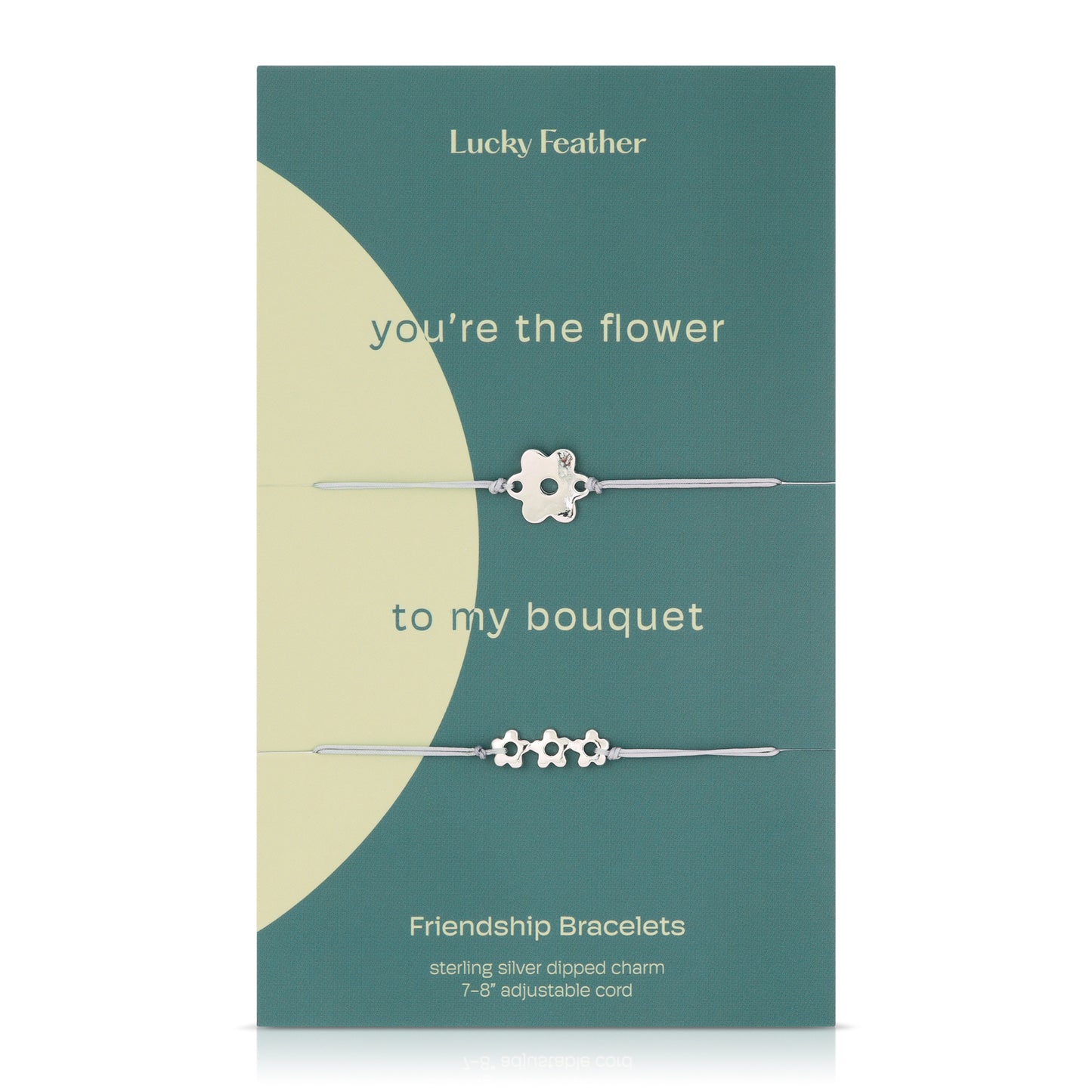 A teal and cream package featuring two silver flower charm friendship bracelets.