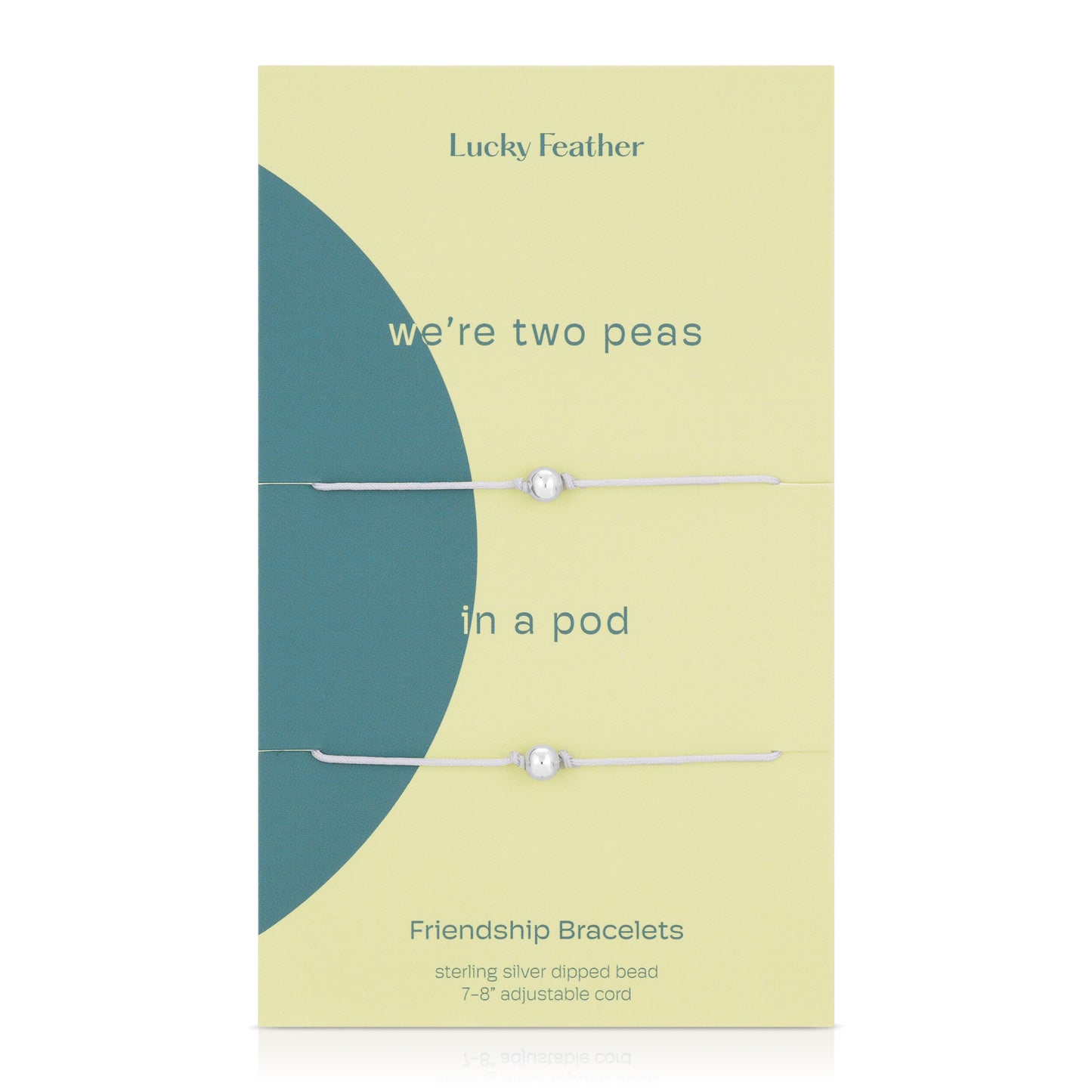 Two "Lucky Feather" friendship bracelets with a silver bead on an adjustable cord, displayed on a light yellow card with "we're two peas in a pod" text and a blue circle design.