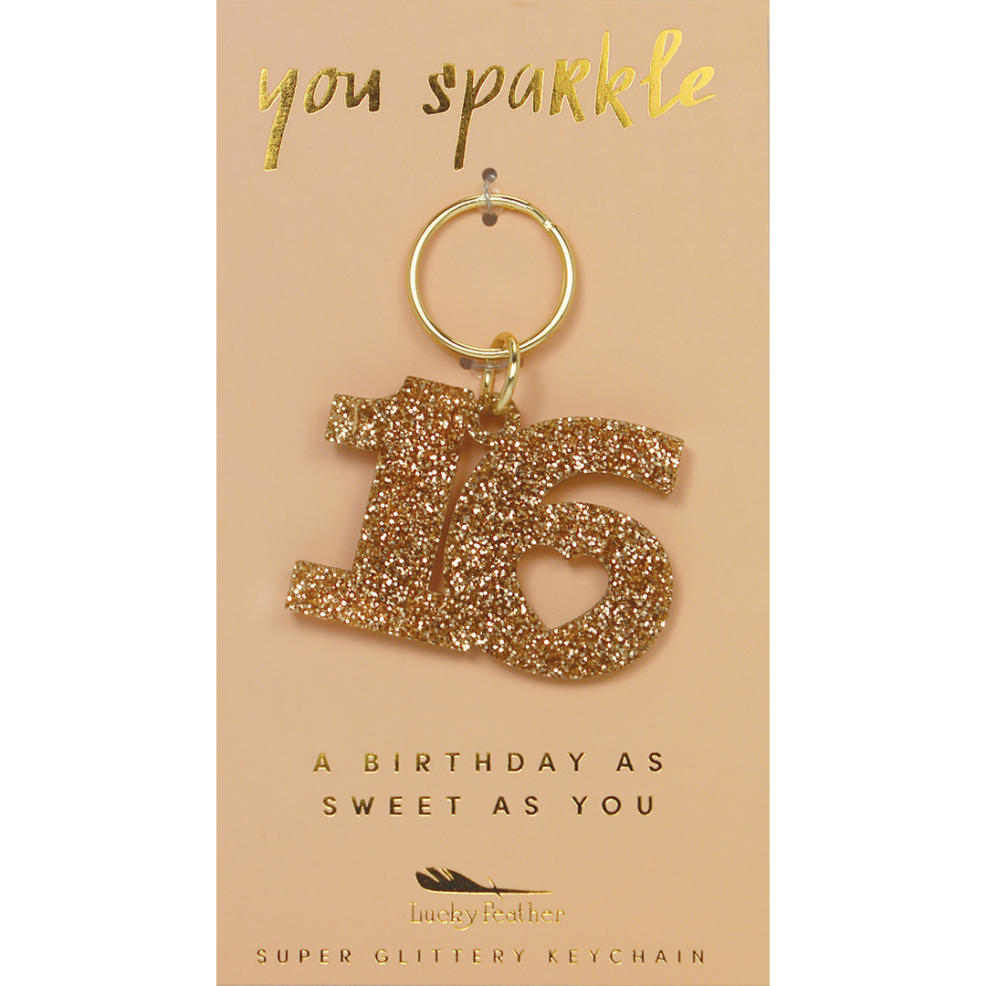 A glittery number 16 keychain hangs on a card that reads 'you sparkle' and 'a birthday as sweet as you.'