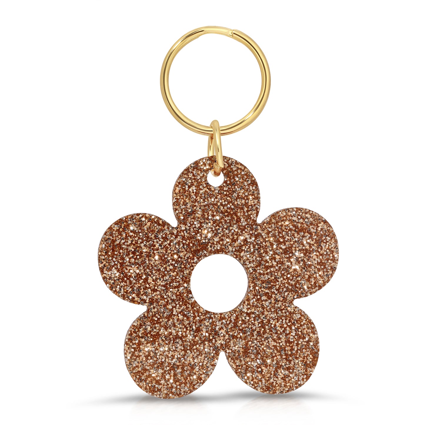 A gold-colored key ring with a glittery copper flower-shaped charm hangs against a white background.
