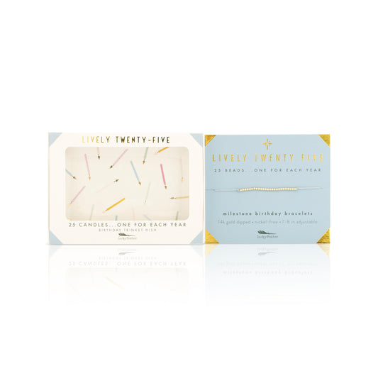 Two "Lively Twenty-Five" gift sets, one containing 25 birthday candles and the other a "milestone birthday bracelet," are reflected on a white surface.
