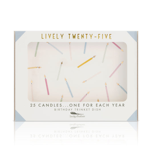 The image shows the packaging for a "Lucky Feather" birthday trinket dish with "Lively Twenty-Five" printed in gold and an illustration of 25 candles.