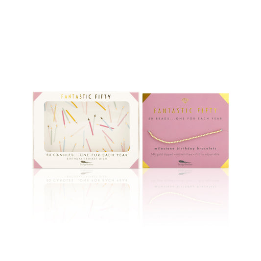 Two "Fantastic Fifty" gift items from Lucky Feather are displayed: a birthday trinket dish featuring candles and a 14k gold-dipped milestone birthday bracelet.
