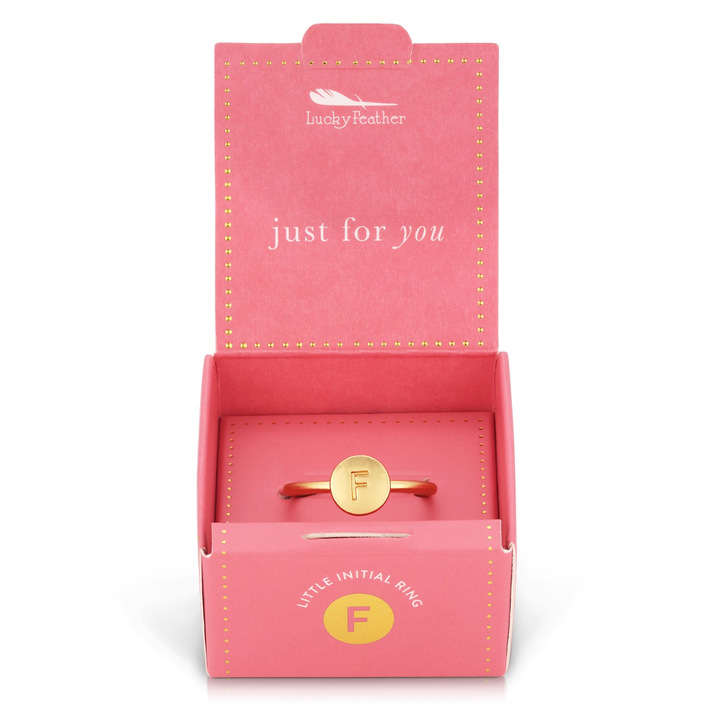 A gold ring with the letter "F" is displayed inside an open pink "Lucky Feather" gift box that reads "just for you."